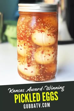 pickled eggs in a mason jar with text reading kansas award winning pickled eggs