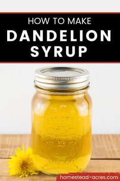 a jar filled with dandelion syrup on top of a wooden table