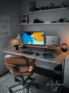 a desk with a computer and headphones on it