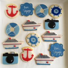 decorated cookies in the shape of boats, ships, and cameras are displayed on a sheet of paper