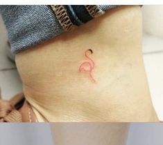 a woman's stomach with a small pink tattoo on her lower body and bottom