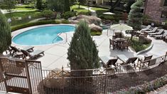 an outdoor swimming pool surrounded by patio furniture