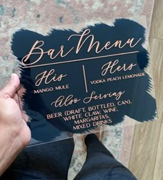 a person holding up a sign that says bar menu