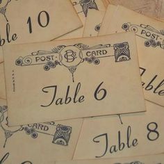 old fashioned wedding table numbers are laid out on top of each other for guests to sign