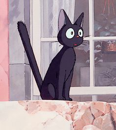 a black cat sitting on top of a window sill next to a stone wall