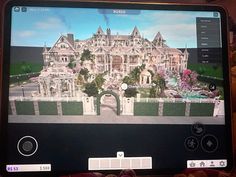 a computer screen showing an image of a large house in the middle of a garden