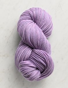 a skein of purple yarn sitting on top of a white counter