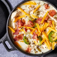 a pan filled with cheese, bacon and peppers