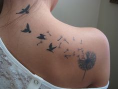 a woman with a dandelion tattoo on her back