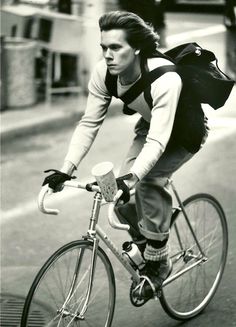 a man riding a bike down the street