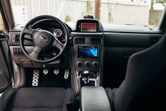 the interior of a car with black leather seats and dash board, steering wheel and dashboard