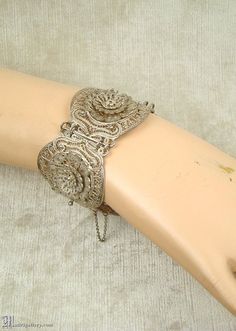 "(Description is below) ALL DELIVERY DATES mentioned by Etsy are ESTIMATES, no delivery date or range is guaranteed, though most of our orders arrive ahead of estimate.  LAYAWAY IS AVAILABLE, typically with a 20% deposit. Please contact us to arrange.  Big antique bracelet, ornate dimensional Etruscan silver (900, tested) filigree panels, original fine silver safety chain, box tab clasp. Measures just over 7.75\" with the clasp closed. Condition is excellent with age appropriate wear.  As with a Ornate Silver Bracelets For Festivals, Vintage Festival Bracelet Jewelry, Vintage Festival Jewelry Bracelet, Antique Bracelets With Intricate Design For Festive Occasions, Antique Bracelet With Intricate Design For Festive Occasions, Festival Intricate Design Silver Jewelry, Vintage Jewelry For Festivals With Intricate Design, Antique Silver Jewelry For Festival, Ornate Antique Silver Jewelry For Festival