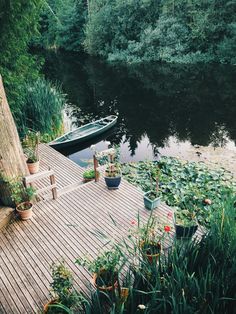 there is a boat that is docked on the dock next to the water's edge