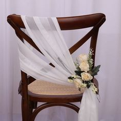 a chair with a white sash draped over it's back and flowers on the seat