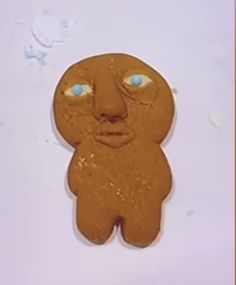 a cookie shaped like a man with blue eyes