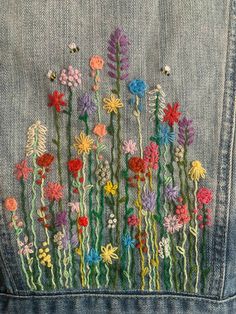 a jean jacket with flowers embroidered on it