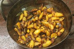 some food is cooking in a frying pan on the stove top and ready to be eaten