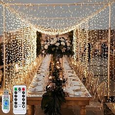 the table is set with candles, plates and remotes for an elegant dinner party