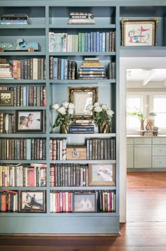 a bookshelf filled with lots of books next to a doorway