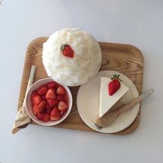 there is a piece of cake and some strawberries on the plate next to it