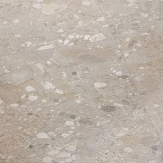 a white toilet sitting on top of a tiled floor