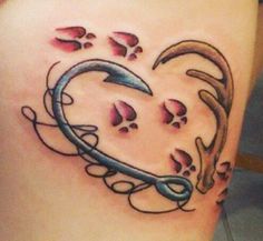 a heart shaped tattoo on the side of a woman's stomach with paw prints