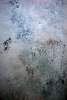 an abstract painting with blue and grey colors on the wall, including rusted paint