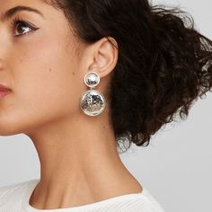 Featuring a signature IPPOLITA silhouette, these earrings combine two round discs of 925 silver, gently textured by hand. The graduating drops are united into a dangling profile that secures with a clip-back closure. Wear them to elevate daytime outfits or dressier evening looks. • Sterling Silver • Length: 1.96" Width: 1.18" • Excluded from promotion Silver Hammered Drop Earrings, Elegant Metal Round Disc Earrings, Textured Silver Metal Jewelry, Modern Silver Round Disc Earrings, Hammered Silver Jewelry For Party, Elegant Silver Hammered Earrings, Elegant Silver Disc Earrings, Elegant Textured Silver Jewelry, Silver Hammered Round Earrings