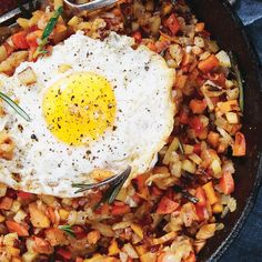 a skillet filled with fried eggs and vegetables