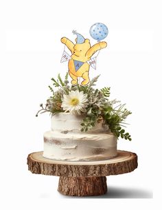 a winnie the pooh cake with flowers and balloons on top is sitting on a tree stump