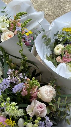 two bouquets of flowers are sitting on the ground