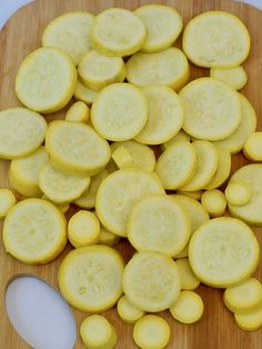 sliced yellow cucumbers on a wooden cutting board