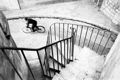 a man riding a bike down a set of stairs next to a metal hand rail