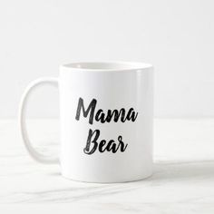 a white coffee mug with the words mama bear written in black ink on it's side