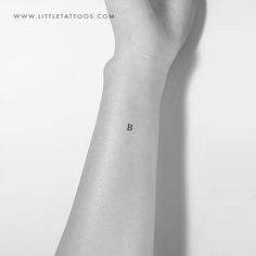 a person's arm with a small tattoo on the left side of their wrist