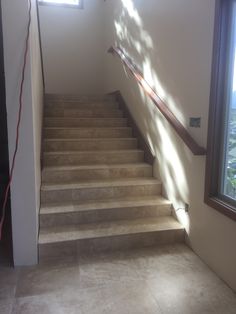 an empty staircase leading up to a window