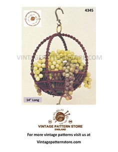 an old fashioned basket with grapes hanging from it's hooks and the words vintage pattern store