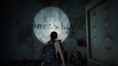 a person with a backpack standing in front of a wall that says, there is no light