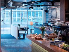 an open kitchen with lots of food on the counter and in front of glass walls