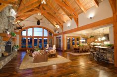 a living room filled with furniture and a fire place in front of a stone fireplace