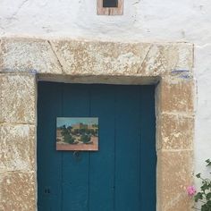 a blue door with a painting on it