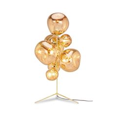 a lamp that is on top of a metal stand with four balls attached to it