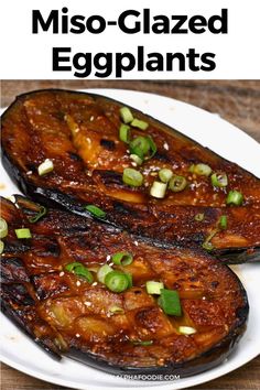 grilled eggplant on a white plate with green onions