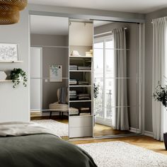 a bedroom with an open closet in the middle and a bed on the other side