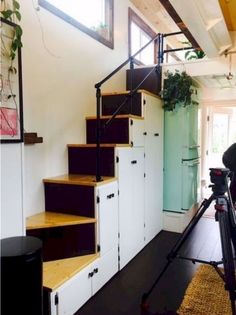 a camera is set up to take pictures of some stairs in a house with white walls and wood floors