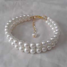 WARM PROMPT: The correct measurement of the length of the bracelet is:the length of the wrist +0.5-1 inch = the length of the bracelet. Welcome back to my shop: https://www.etsy.com/shop/pearlandjewelry Description of the product in the picture: I make the two Strands Pearl bracelet with 6mm ivory glass pearls , They use golden accessories.The bracelet lengh is 7.5 inches,IT has a 2 inch long adjustable chain,It is nice for your wedding. The picture color is ivory. Can choose other colors are:iv Adjustable Pearl Wedding Bracelet, White Beaded Bracelet With Pearl Chain For Wedding, White Pearl Chain Bracelet For Wedding, Golden Accessories, Ivory Pearl Necklace, Pearl Bridesmaid Jewelry, Ivory Necklace, Pearl Bracelet Wedding, Pearl Jewelry Wedding