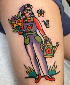 a woman with flowers and watering can tattoo on her thigh, holding a watering can