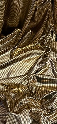 the fabric is shiny and gold in color