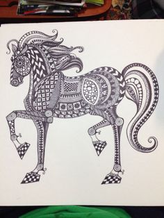 a black and white drawing of a horse with intricate patterns on it's body