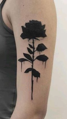 a black rose tattoo on the left upper arm